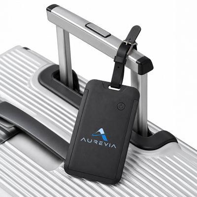 Jet Luggage Tag Tracker - A black luggage tag tracker attached to the handle of a silver suitcase, featuring a logo.