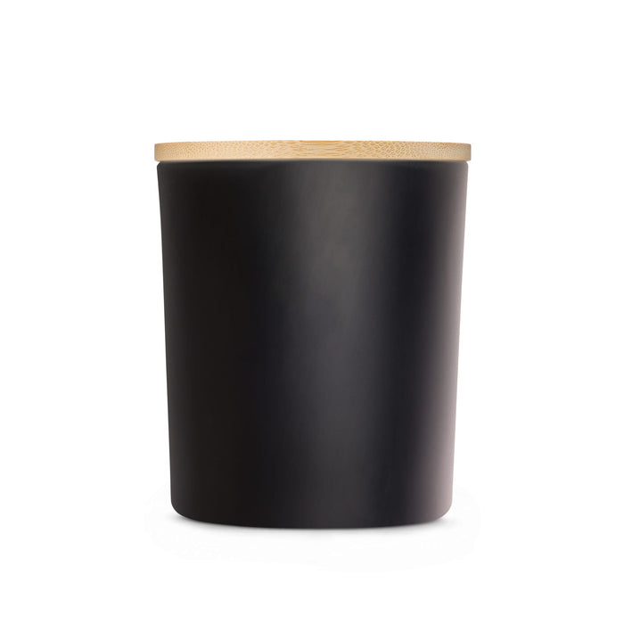 The Warm Welcome - A large black glass candle with a smooth finish and a bamboo lid. Minimalistic design with a sleek appearance.