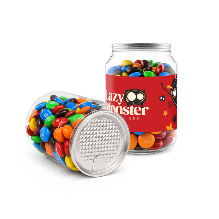 M&M's in Clear Can 180g - A clear canister filled with colourful M&M's, featuring a playful design and a logo on the side.