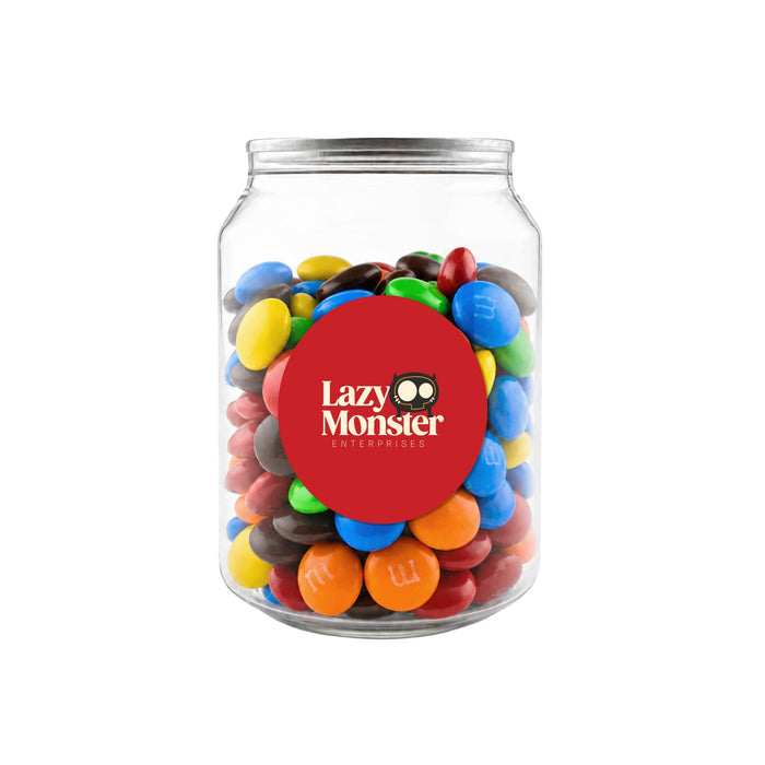 M&M's in Clear Can 180g - A clear jar containing M&M's in various colours, including red, blue, yellow, green, brown, and orange.