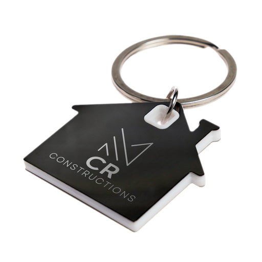 House Stainless Steel Keytag - A keytag shaped like a house in black and white, featuring a circular keyring and a logo.