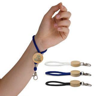Luxeloop Keytag - A hand holds a blue cord keytag with a wooden circular attachment, alongside black and white keytags.
