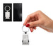 Frame Keytag - A silver rectangular keytag held in a hand, displayed in a black gift box. The keytag features a logo.