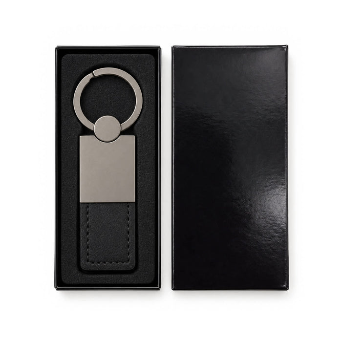 Mario Keytag - A sleek silver keytag with a leather strap, displayed in a black gift box.