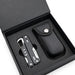 Trail Multi Tool - A black multi-tool lies inside a black box with a textured case, featuring a silver tool with various functions.