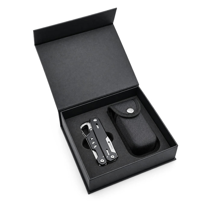 Trail Multi Tool - A black multi-tool and its carrying case inside a black box. The tool features various metallic attachments.