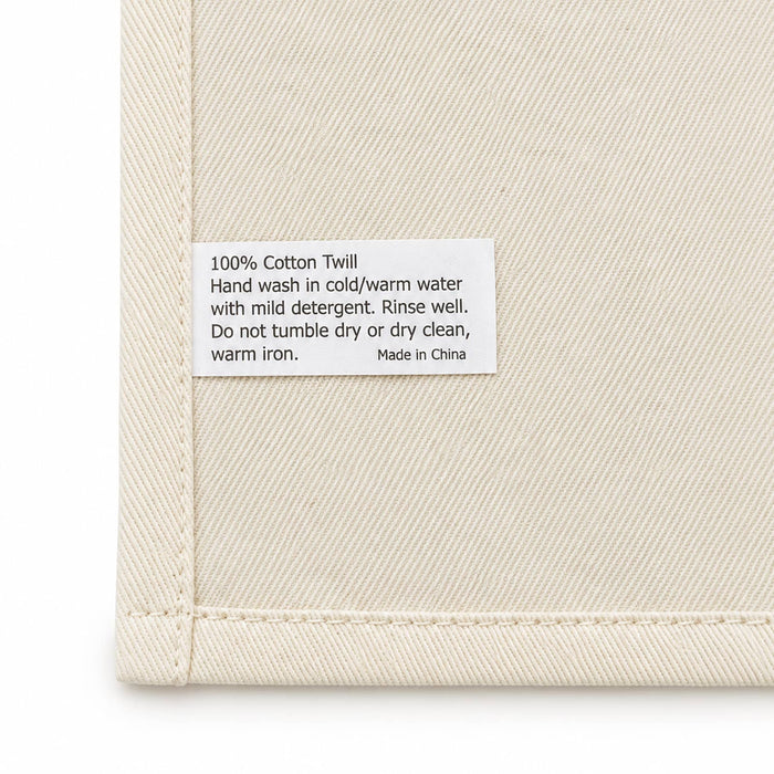 Haven Large Cotton Tea Towel - A cream cotton tea towel featuring a care label with washing instructions and a brand logo.