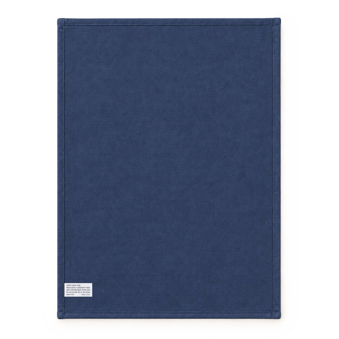 Haven Large Cotton Tea Towel - A large navy blue cotton tea towel with stitched edges and a small branding label at the bottom.