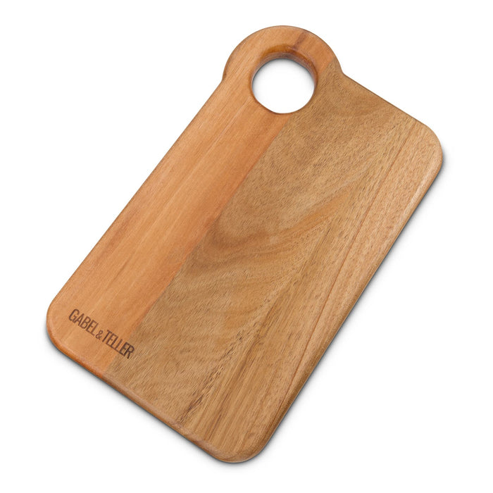 The Carry-On Graze - A wooden chopping board with a round handle, featuring a natural finish and a subtle brand logo.