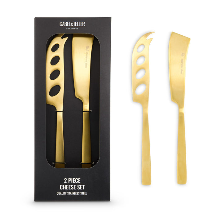 The Coastal Edit - A cheese set featuring two stainless steel knives with a gold finish, presented in a black box.
