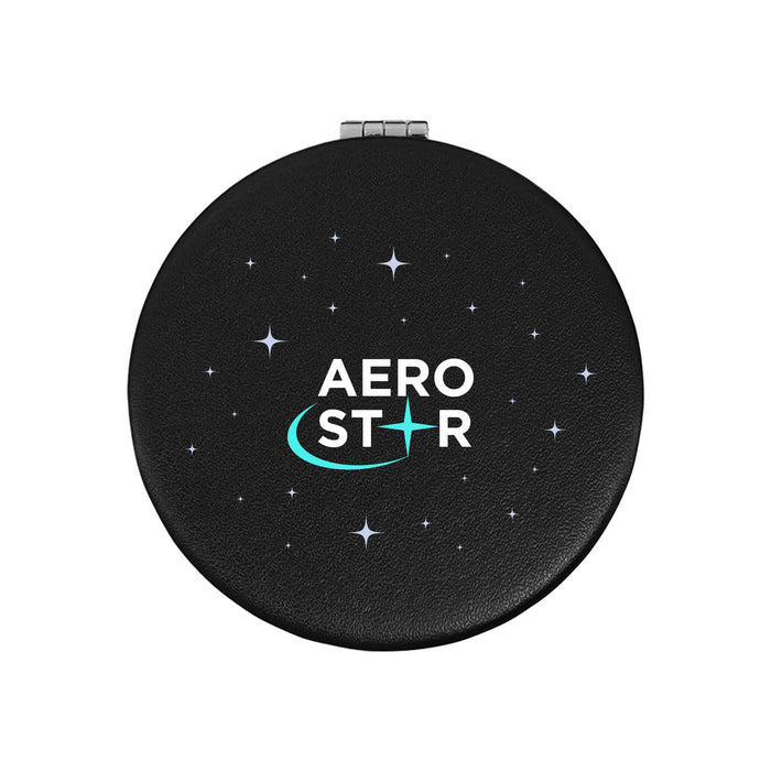 The Polished Traveller - A round, black compact with a starry design and a logo in the centre.