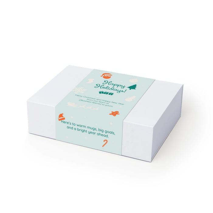 The Ultimate Welcome - Tea Edition - A white gift box featuring a light blue label with holiday-themed illustrations and a festive message.