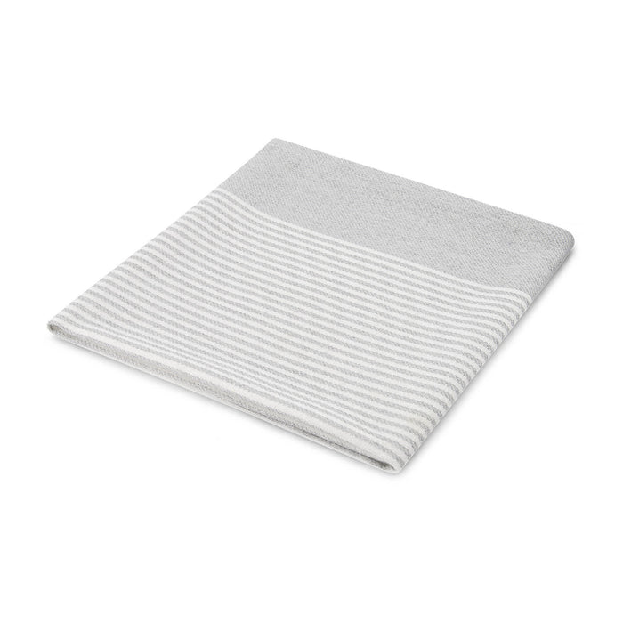 The Warm Welcome - A folded grey towel with a striped design at the top. It features a soft texture and a simple, modern look.