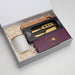 The Host Edit - A gift box containing a cheese knife set, a wooden serving board, and a cup, arranged with white filler.