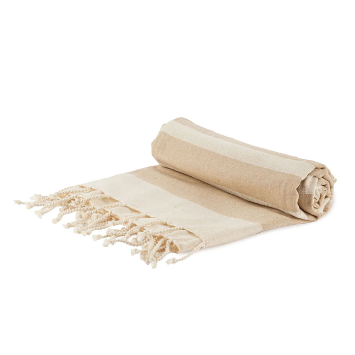 The Courtside Carry - A rolled beige and cream striped picnic blanket with fringed edges, featuring a simple design. It has a logo.