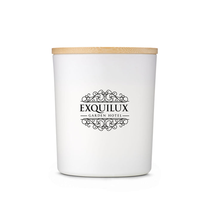 Glow & Graze - A white container with a wooden lid, featuring an ornate black logo for Exquilux Garden Hotel.