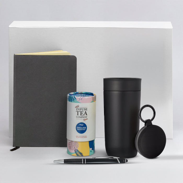 The Ultimate Welcome - Tea Edition - A black drink bottle, a grey notebook, a pen, a tea canister, and a small black accessory with a logo.