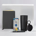 The Ultimate Welcome - Tea Edition - A black drink bottle, a grey notebook, a pen, a tea canister, and a small black accessory with a logo.