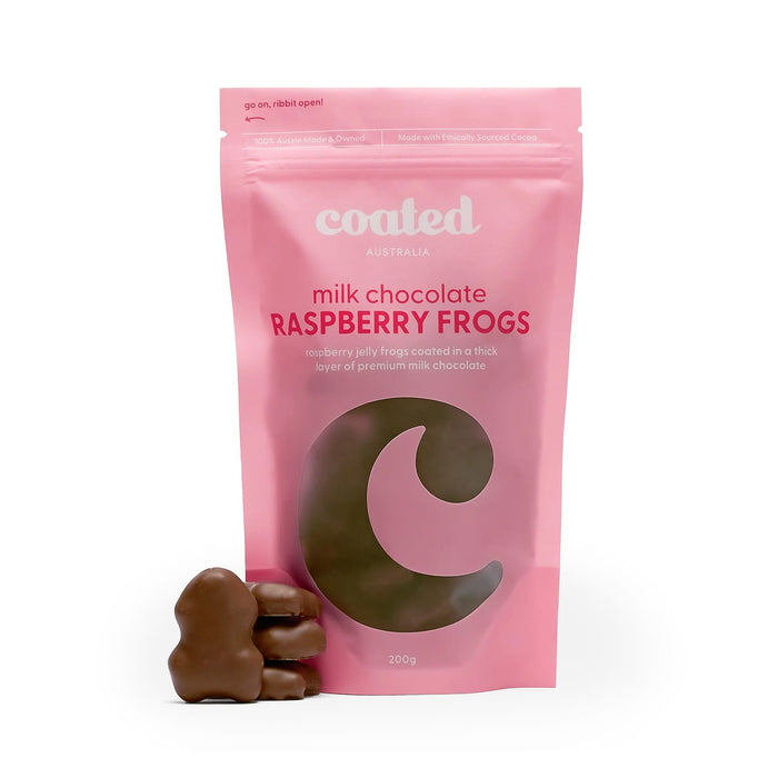 The Generous Host - A pink bag of Coated Australia milk chocolate raspberry frogs with three chocolate-covered frogs in front.
