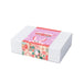The Generous Host - A gift box with a pastel pink design featuring bunny illustrations and decorative patterns, secured with a printed band.