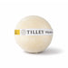 The Cosy Indulgence - A bath bomb in a round shape, cream-coloured with a yellow label featuring branding.