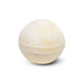 The Cosy Indulgence - A bath bomb in a spherical shape, featuring a pale yellow hue with a smooth texture. It has a simple design.