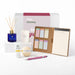 The Mindful Moment - A collection of wellness products including a diffuser, candle, cream, bath bomb, notepad, and pink pen.