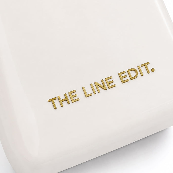 Pavilion Cooler by The Line Edit. - A cream cooler featuring a simple, sleek design with a gold logo.