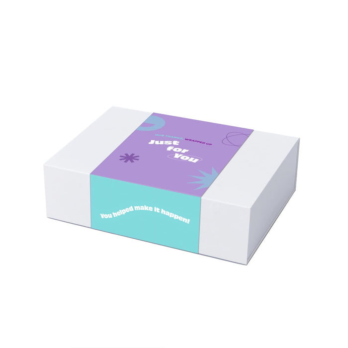 The Big Indulge - A gift box with a purple and turquoise design, featuring a logo and decorative elements.