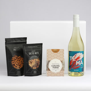 The Perfect Pairing - A drink bottle of white wine accompanied by salt pretzels, salted nuts, and caramel fudge, all in branded packaging.