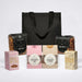 The Treat Kit - A black cooler bag filled with pretzels, beer nuts, and assorted sweet treats including coconut ice, caramel fudge, and marshmallows.