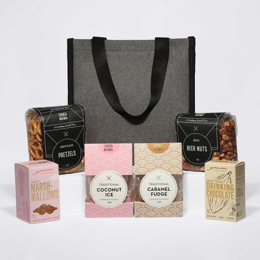 The Treat Kit - A grey cooler bag with assorted snacks: pretzels, beer nuts, marshmallows, traditional coconut ice, caramel fudge, and drinking chocolate.