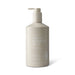 The Pamper & Entertain Edit - A hand and body wash in a beige pump bottle with a logo, featuring sea salt and pearl extract.