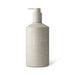 The Coastal Edit - A cream bottle in a neutral beige shade with a pump dispenser, featuring a logo and "Great Barrier Reef" branding.