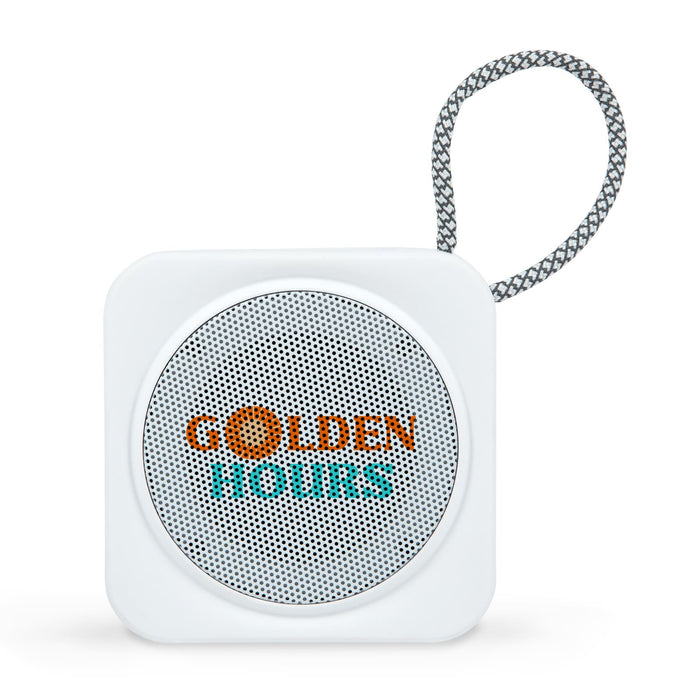 The Escape Pack - A square white portable speaker with a mesh grille and a looped strap, featuring a logo on the front.