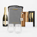 The Pour & Gather Hamper - A grey insulated hamper containing a bottle of sparkling wine, two glass tumblers, a wooden cutting board, and a knife set.