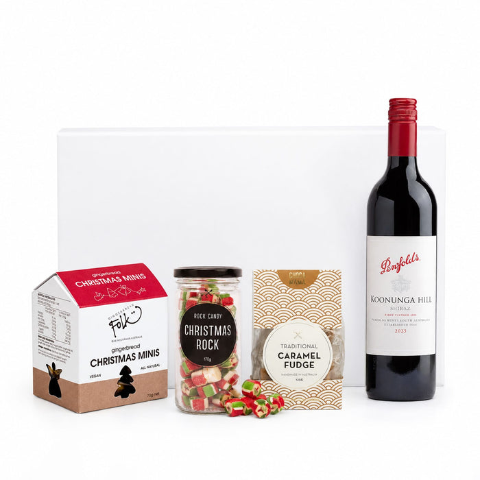 The Perfect Pairing: Christmas Edition - A drink bottle of red wine, a jar of rock candy, and various festive sweets in colourful packaging.