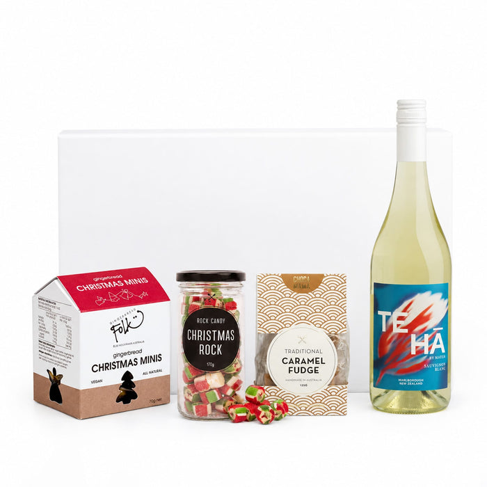The Perfect Pairing: Christmas Edition - A drink bottle and assorted festive treats including Christmas Minis, Christmas Rock candy, and caramel fudge in various packaging.