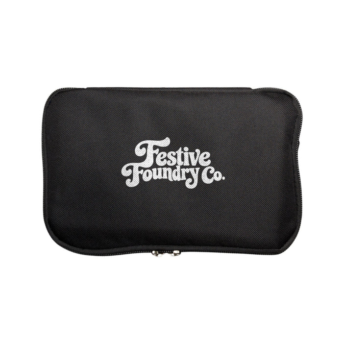 The Knock Off for Christmas Pack - A black zippered case with a logo featuring the words "Festive Foundry Co." in white.
