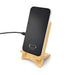 Oscar Illuminating Charging Stand - A bamboo charging stand holds a smartphone that is plugged in and indicating a charging status.