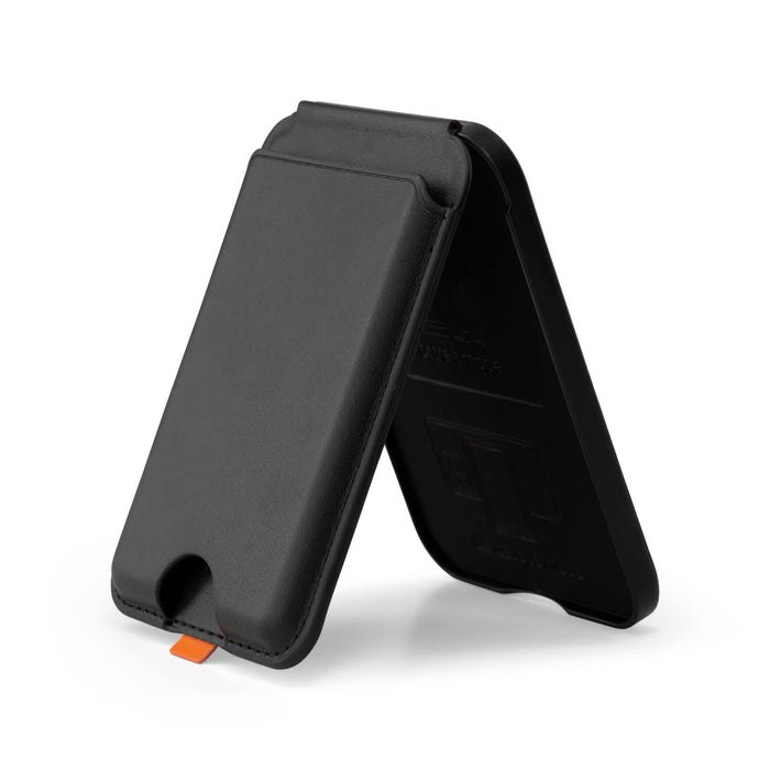 Cozy Phone Wallet - A black phone wallet with a stand feature, designed to hold a phone and cards. It has a small orange detail.