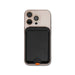 Cozy Phone Wallet - A mobile phone in a pink case with a black wallet attached to the back. The wallet features a logo.