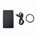 The Modern Essential Gift Set - A black solid state power bank, a USB-C cable, and a circular accessory. The product features a logo.