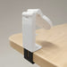 Traveler Mobile Phone Stand - A white mobile phone stand clamps onto a wooden surface, featuring an adjustable holder for the device.