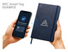Essentials A5 Notebook - A navy blue notepad with an NFC tag feature next to a smartphone displaying a detected tag notification.