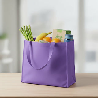 Medium Non Woven Tote - A purple non-woven tote filled with bananas, oranges, asparagus, and a drink bottle. It has two handles.