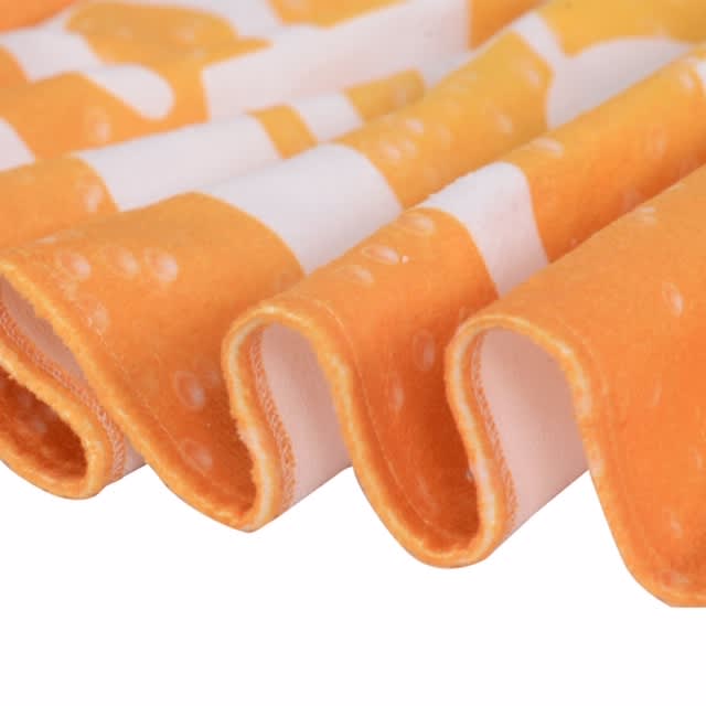 Bath Towel - An orange and white patterned face washer with a soft, textured edge, featuring a wavy fold. It has a branding logo.