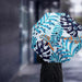 Full Colour Poppins Umbrella - A full-colour umbrella featuring a tropical design with blue, green, and orange patterns against a white background.