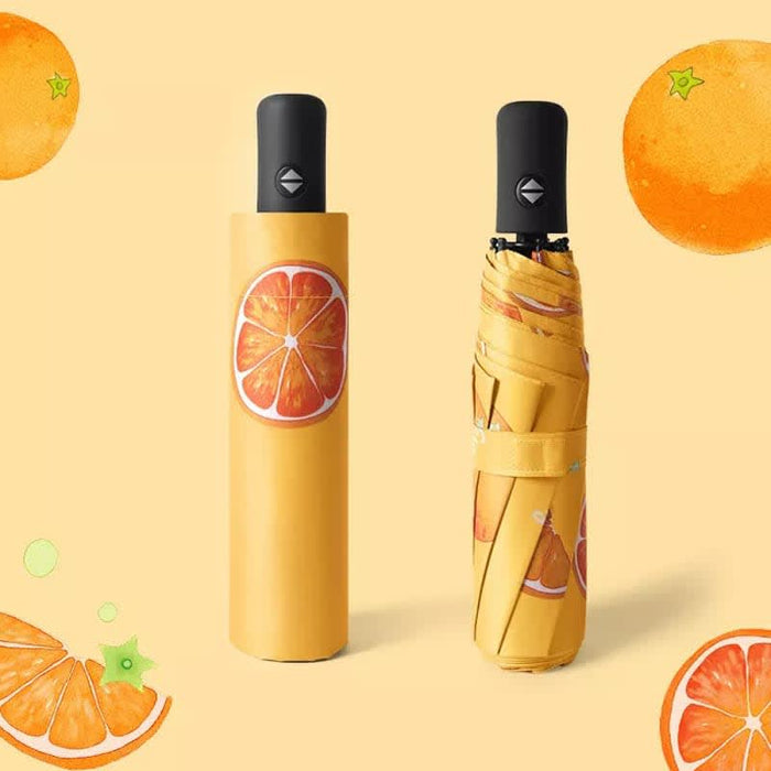 Full Colour Poppins Umbrella - A yellow umbrella with a fruit design, featuring orange slices, folded and unfurled, against a bright background.