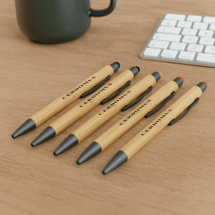 Manopoli Bamboo Pen - A set of bamboo pens in natural wood and black, featuring a logo, displayed on a wooden surface.